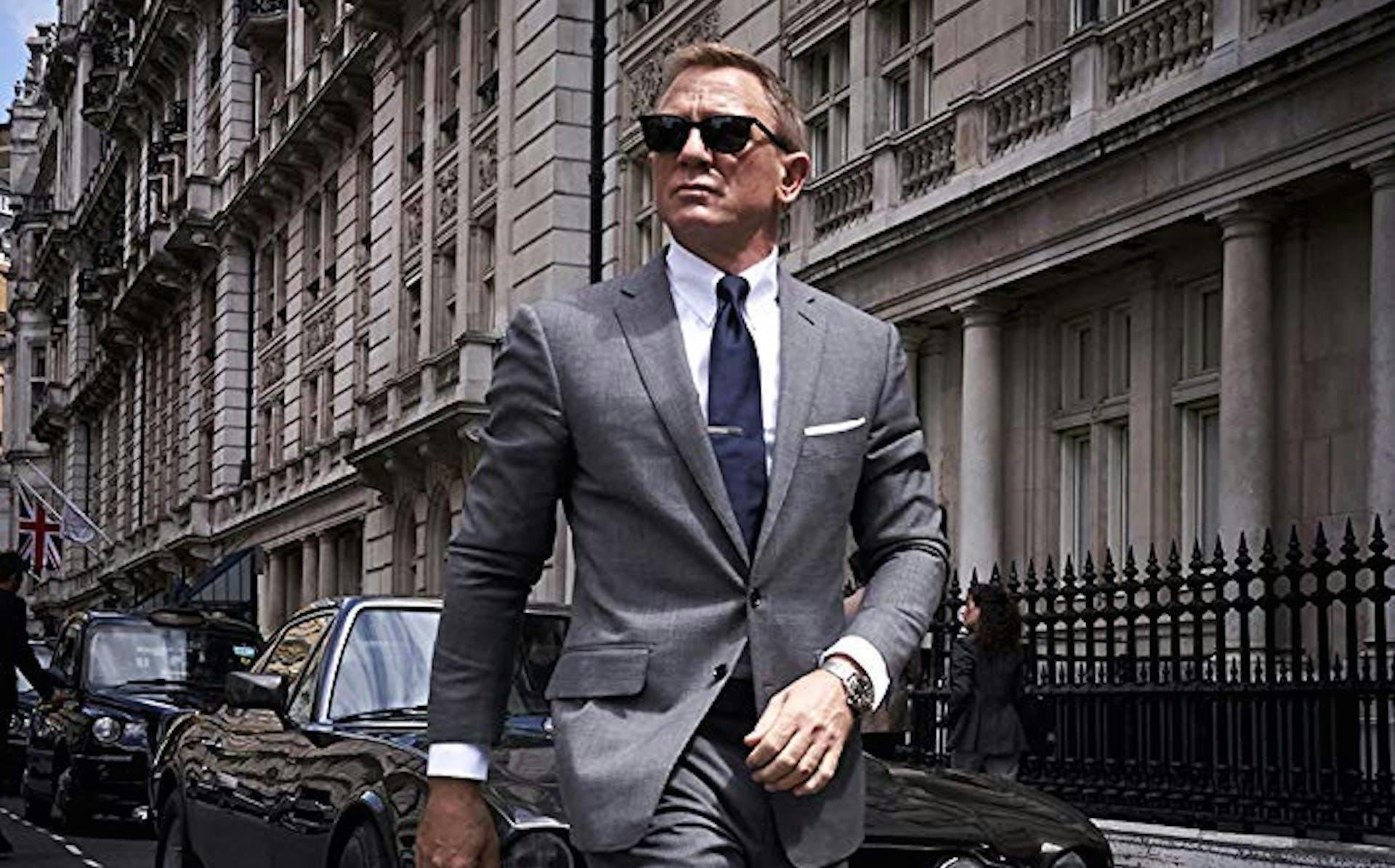 clothing apparel suit overcoat coat person human man sunglasses accessories