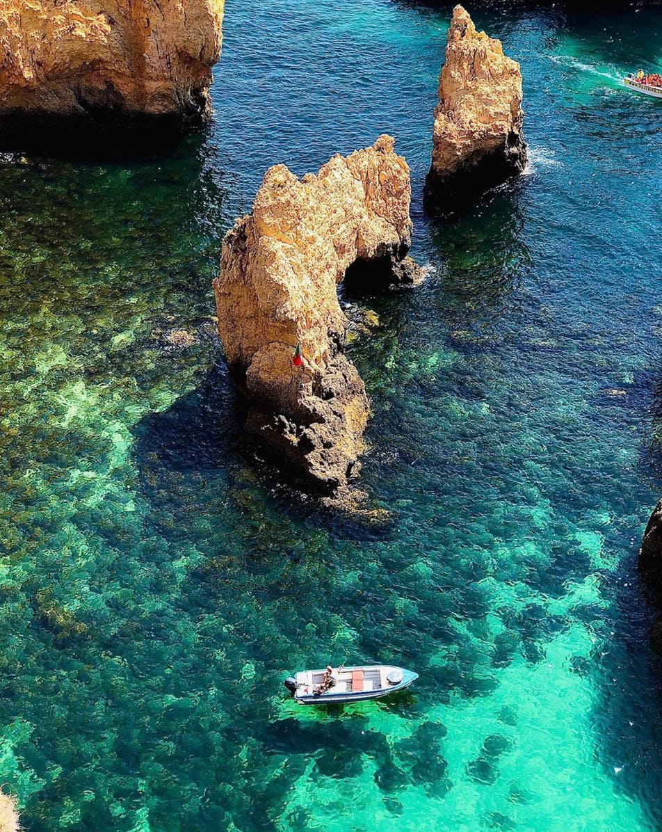 promontory nature water outdoors boat sea shoreline cliff coast rock