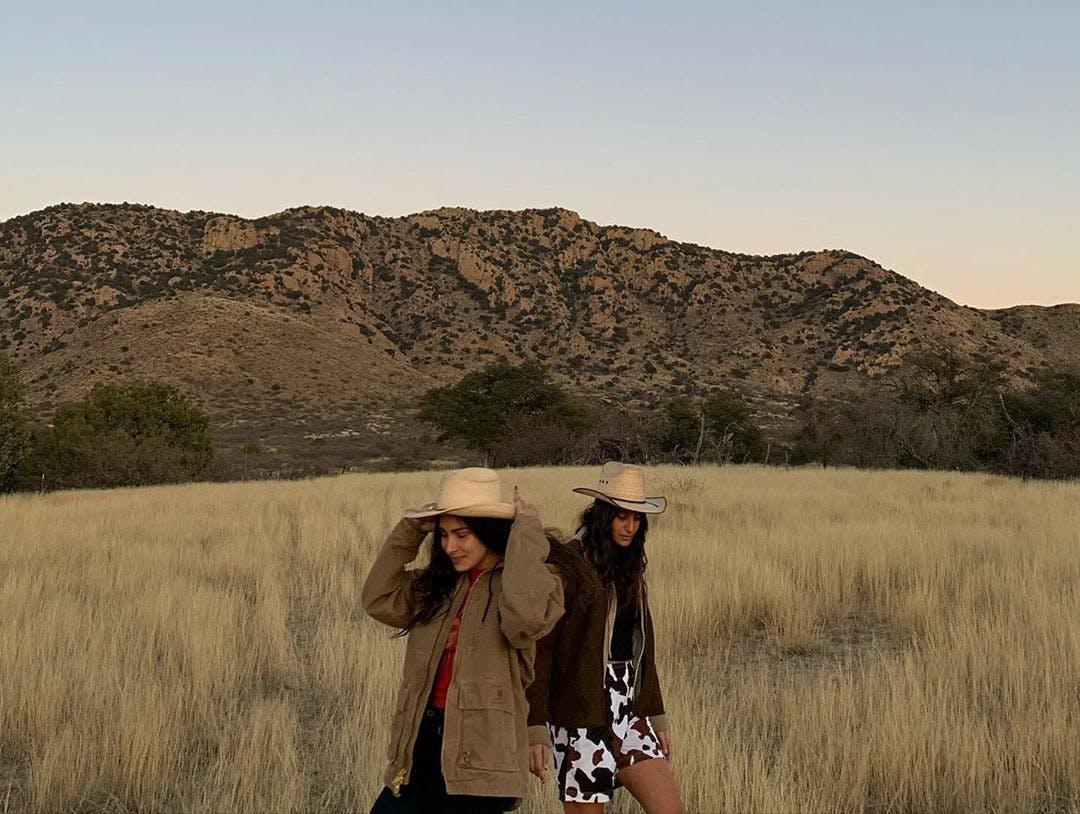 clothing apparel person outdoors cowboy hat hat sun hat grass plant field