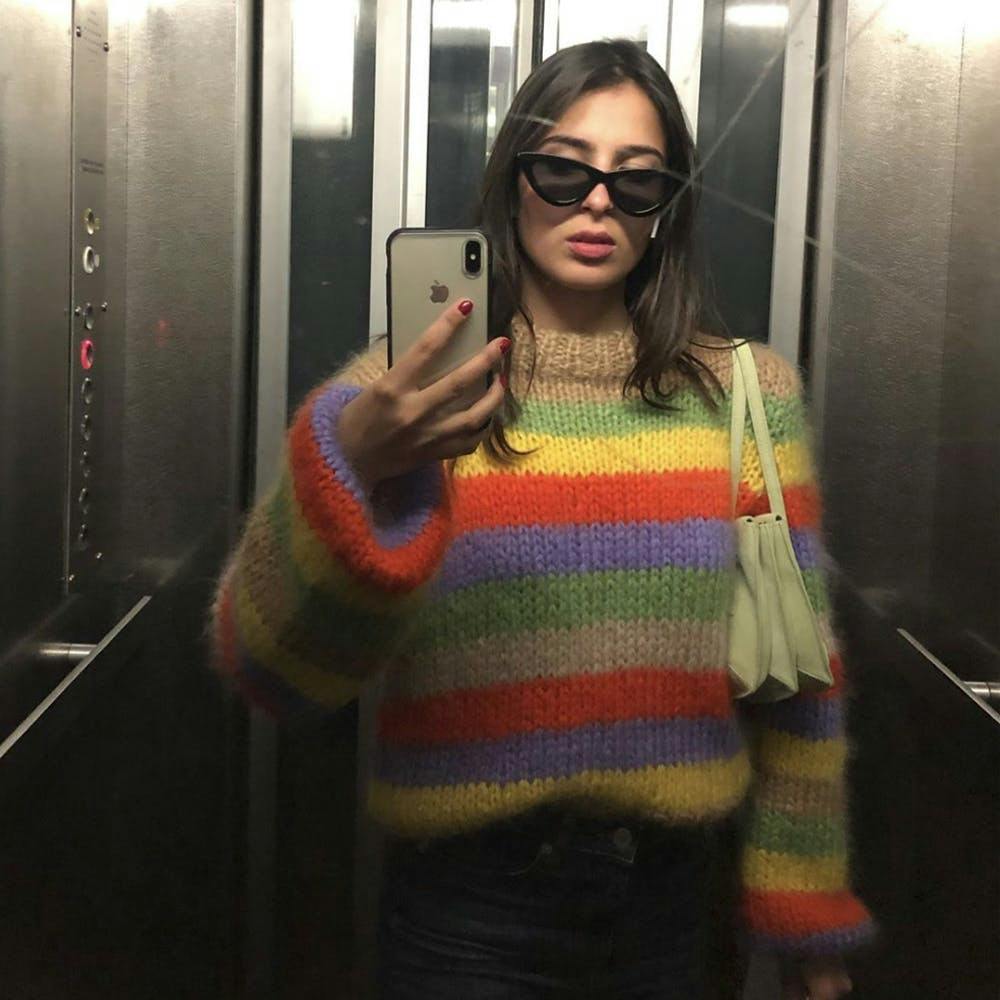 clothing apparel elevator mobile phone electronics phone sunglasses accessories person sweater