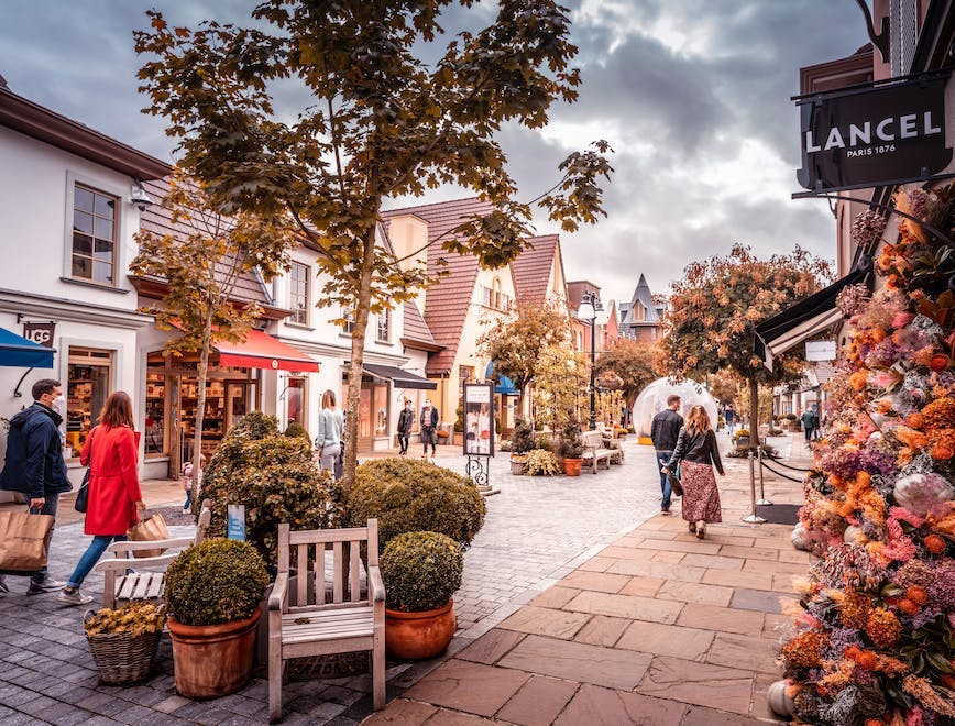 person human flagstone tree plant path walkway city building urban