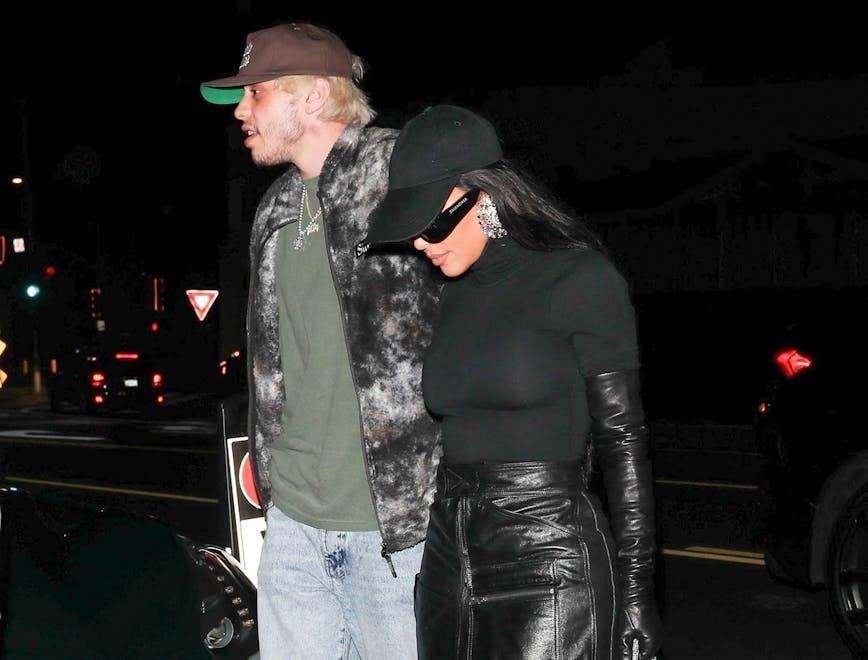 kim kardashian, pete davidson, giorgio baldi, santa monica, comedian, fashion, style, restaurant, meal, dinner, food, black boots, leather skirt, gloves, hat, sunglasses, green t-shirt, jeans, sneakers, love bite, hickey santa monica ca coat jacket pants necklace shoe glove man adult male person