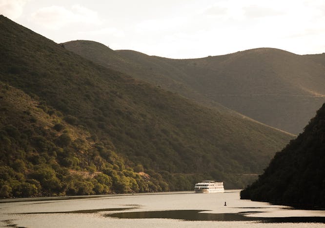 outdoors nature boat vehicle countryside hill water mountain slope promontory