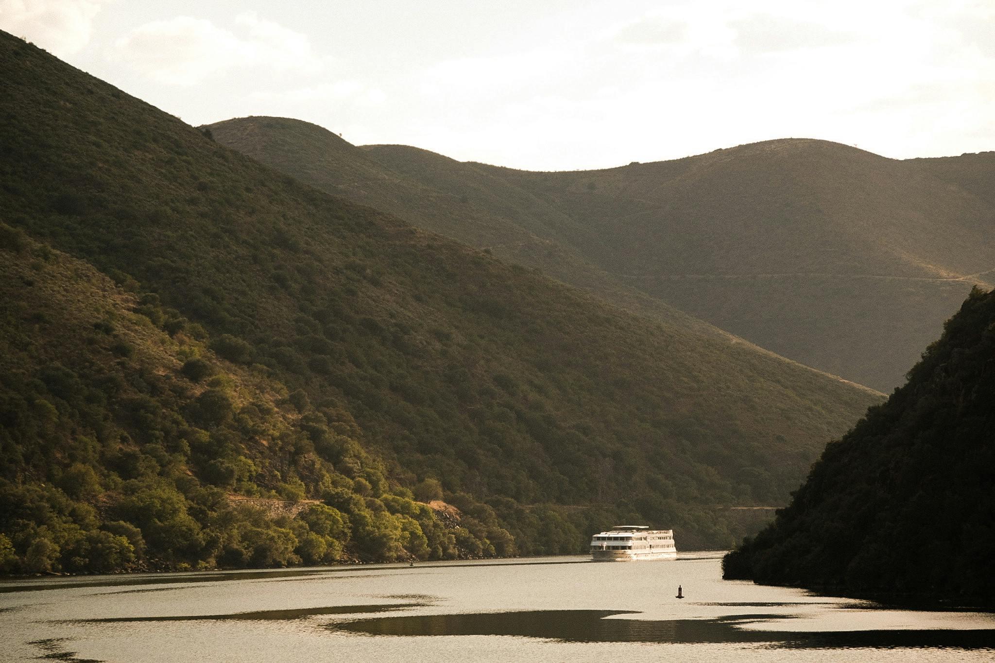 outdoors nature boat vehicle countryside hill water mountain slope promontory